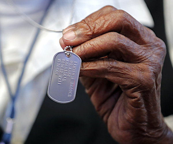 World War II veteran Lawrence Brooks holds a dog tag honoring him as the oldest living World War II veteran, as he celebrates his 110th birthday at the National World War II Museum in New Orleans, Thursday, Sept. 12, 2019. Brooks was born Sept. 12, 1909, and served in the predominantly African-American 91st Engineer Battalion, which was stationed in New Guinea and then the Philippines during World War II. He was a servant to three white officers in his battalion. (AP Photo/Gerald Herbert)